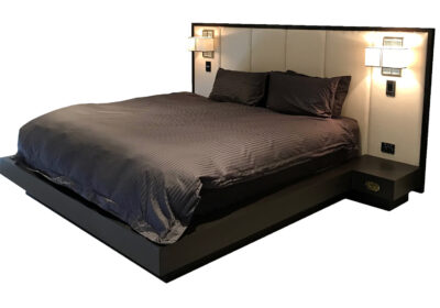 King bed featuring oversize upholstered bedhead and built in bedside tables