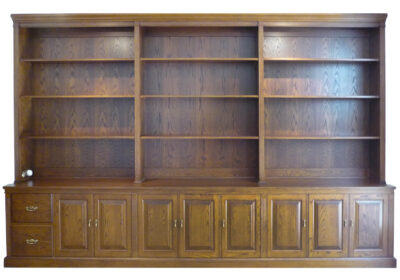 built-in traditional bookcase made to fit with drawers and routered cupboards in american oak