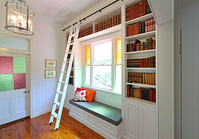 custom-made built-in bookcase ladder and window bench
