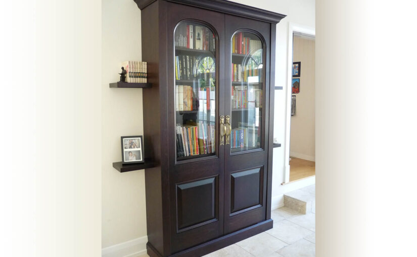 dark timber book cabinet with beautiful brass handles