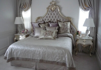 decadent king bed featuing deep buttoned upholstery and gilded carving