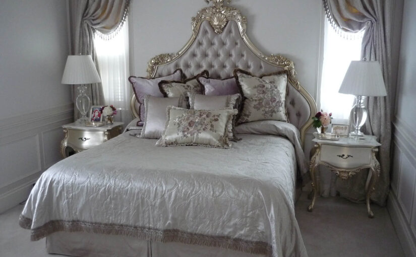 decadent king bed featuing deep buttoned upholstery and gilded carving