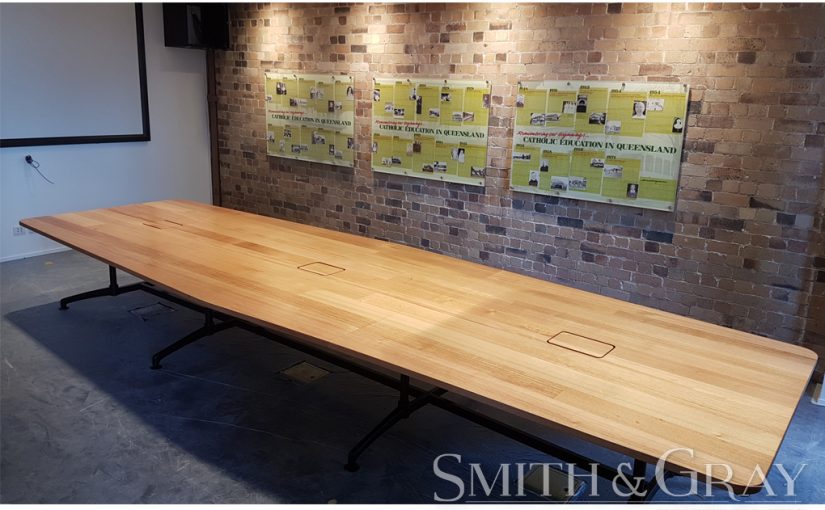 Custom made boardroom table in solid Tas oak and a steel base.